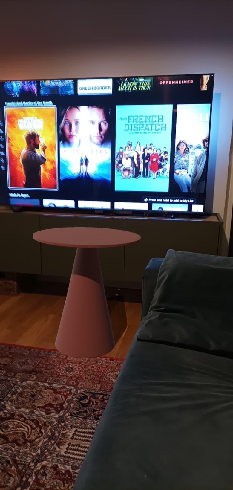 Virtualdom AR placement: a side table standing in a living room, seen through the phone camera.